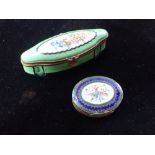 A PORCELAIN PILLBOX decorated with flowers and an enamel pillbox with a spray of flowers and mirrore