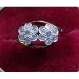 A DIAMOND FLORAL CROSSOVER RING, on a 18ct gold shank, ring size H-I