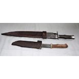 A STEVE BROOKS HAND-FORGED BOWIE KNIFE, the steel blade with steel and mahogany grip, in leather she