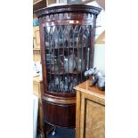 A GEORGE III STYLE BOW-FRONT GLAZED CORNER CABINET WITH DENTIL CORNICE
