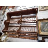 A 'PENNY PINE' HANGING PLATE RACK WITH INSET PENNY COIN, 100cms wide