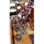 AN ORIENTAL CARVED STUDY OF AN ELDER, 44cm high and three similar (4)