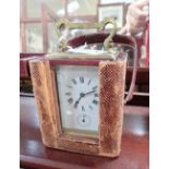 A BRASS CASED CARRIAGE CLOCK, the French movement with alarm, and leather carrying case
