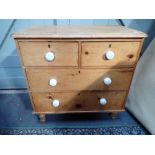 A VICTORIAN STRIPPED PINE CHEST OF DRAWERS with white ceramic knobs, 86cms wide