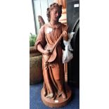 A MOULDED TERRACOTTA FIGURE OF AN ANGEL PLAYING A LUTE, 79cm high