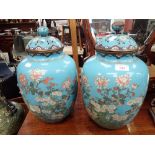 A LARGE PAIR OF CLOISONNE VASES with covers, in powder blue with floral decoration, 40cm high (overa