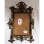 A CONTINENTAL GILT-METAL PHOTOGRAPH FRAME, inset with 'jewels' and cabochons, 28cm high x 16.5cm dep