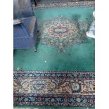 A PERSIAN STYLE N WOVEN WOOL CARPET, the central foliate and floral medallion on a plain teal green