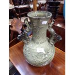 AN ORIENTAL GREEN GLAZED VASE decorated with dragons, 35cm high