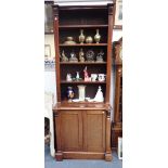 A MAHOGANY BOOKCASE CABINET, circa 1900, the open shelves with carved foliate corbels to each side,