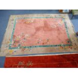 CHINESE STYLE MACHINE WOVEN WOOL CARPET, the rectangular pink field with floral and foliate sprigs a