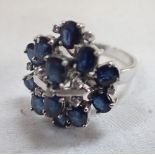 A SAPPHIRE AND DIAMOND CLUSTER RING, on a white gold shank stamped '585', ring size N-O
