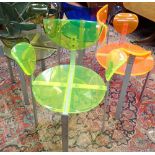 FOUR DIFFERENT COLOURED PERSPEX POST MODERN STEEL FRAMED ARMCHAIRS