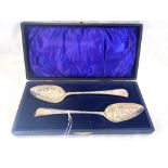 A PAIR OF SILVER BERRY SPOONS with gilt bowls, cased, approximately 120gms