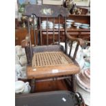 A 19TH CENTURY COMB-BACK ROCKING CHAIR, with caned seat and painted decoration