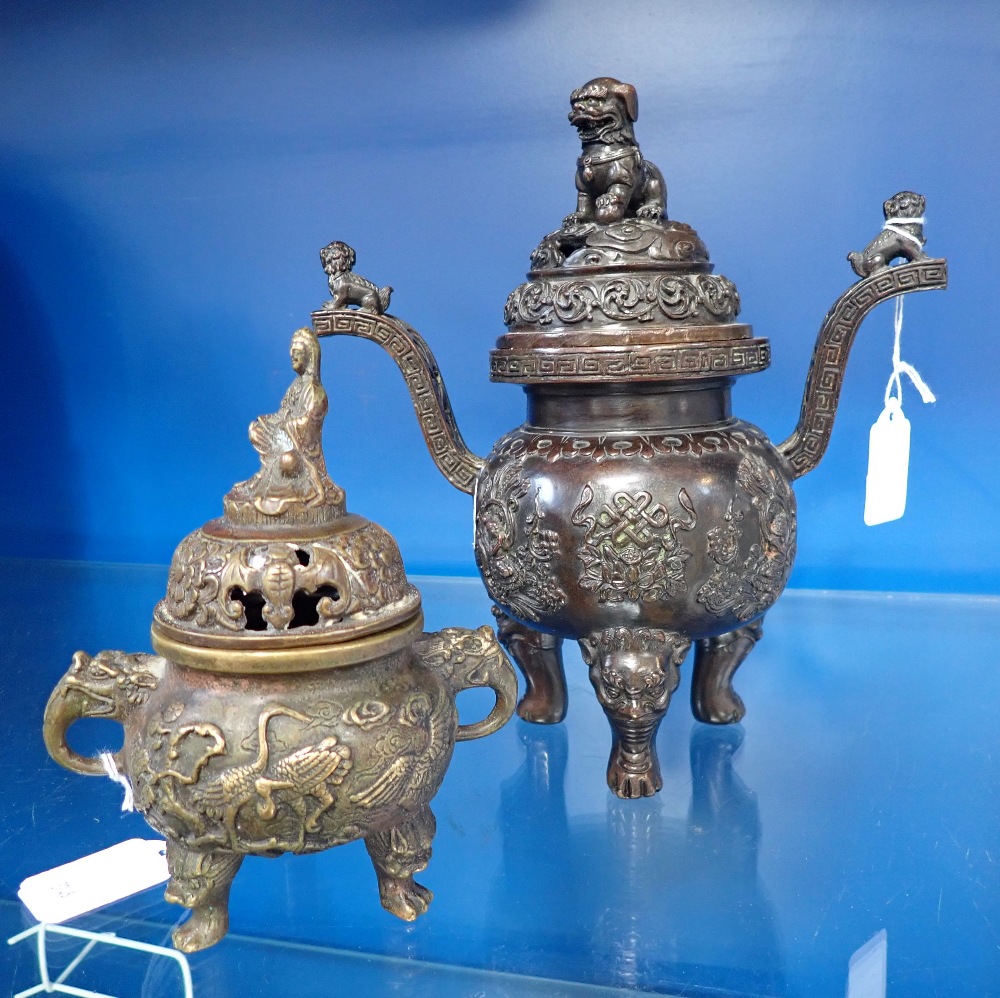 A CHINESE PATINATED BRONZE CENSER with cover decorated with a temple lion and another similar (2)