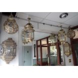 A PAIR OF EASTERN STYLE METAL FRAMED GLAZED WALL LANTERNS and two similar pairs of hanging lanterns