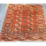 A RED GROUND PERSIAN RUG (frayed and insect damaged) 110cm x 115cm)