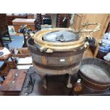 A MAHOGANY AND BRASS BOUND WINE COOLER of oval barrel form on an associated stand, 60cms wide