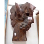 A STYLISED HEAD CARVED FROM A PIECE OF ROOT WOOD, wall mounted 47cms high and a reproduction print o