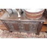 A 17TH CENTURY OAK COFFER with a carved panelled front, 119cm wide