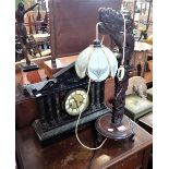 A CHINESE CARVED HARDWOOD TABLE LAMP, an American simulated slate mantel clock and a 1920s oak cased