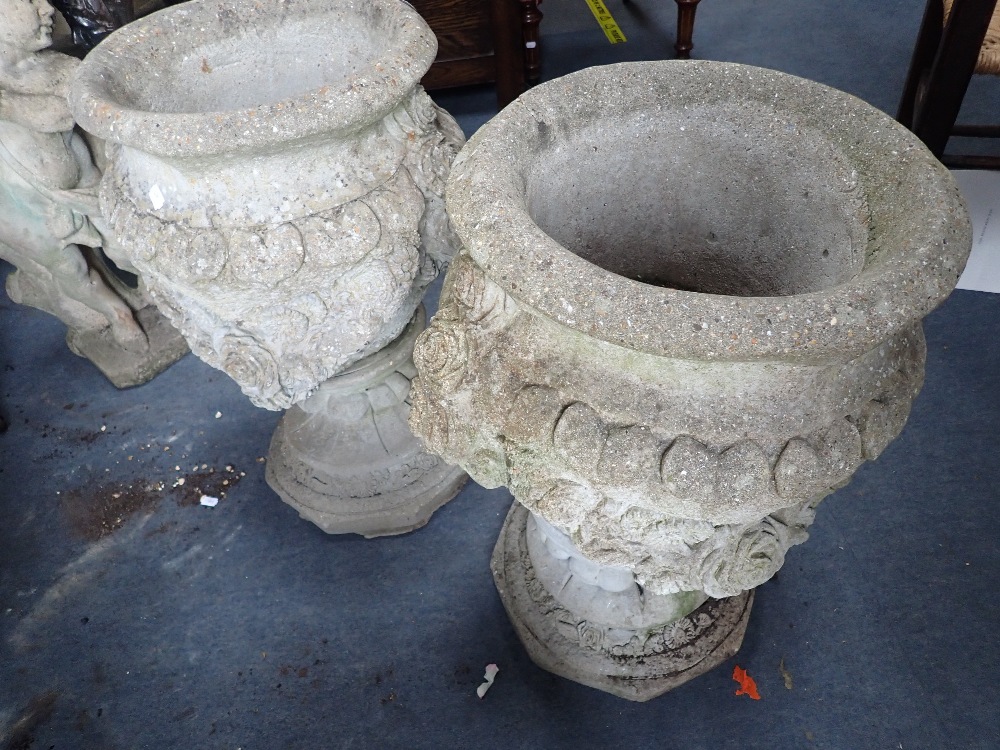 A PAIR OF RECONSTITUTED GARDEN URNS decorated with roses, 65cms high - Image 2 of 2