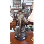 A 19TH CENTURY STYLE BRONZE FIGURE OF A NUDE WOMAN, perched on rock, 64cms