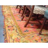 A RED GROUND TURKEY RUG (holed and frayed) 230cm x 245cm