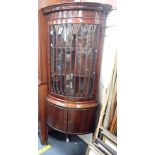 A GEORGE III STYLE BOW-FRONT GLAZED CORNER CABINET WITH DENTIL CORNICE