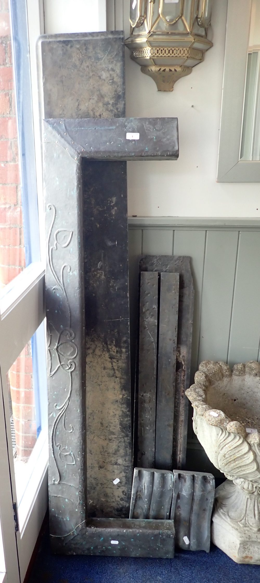 A 19TH CENTURY BLACK SLATE FIRE SURROUND (Dismantled) and an Art Nouveau beaten copper fire kerb