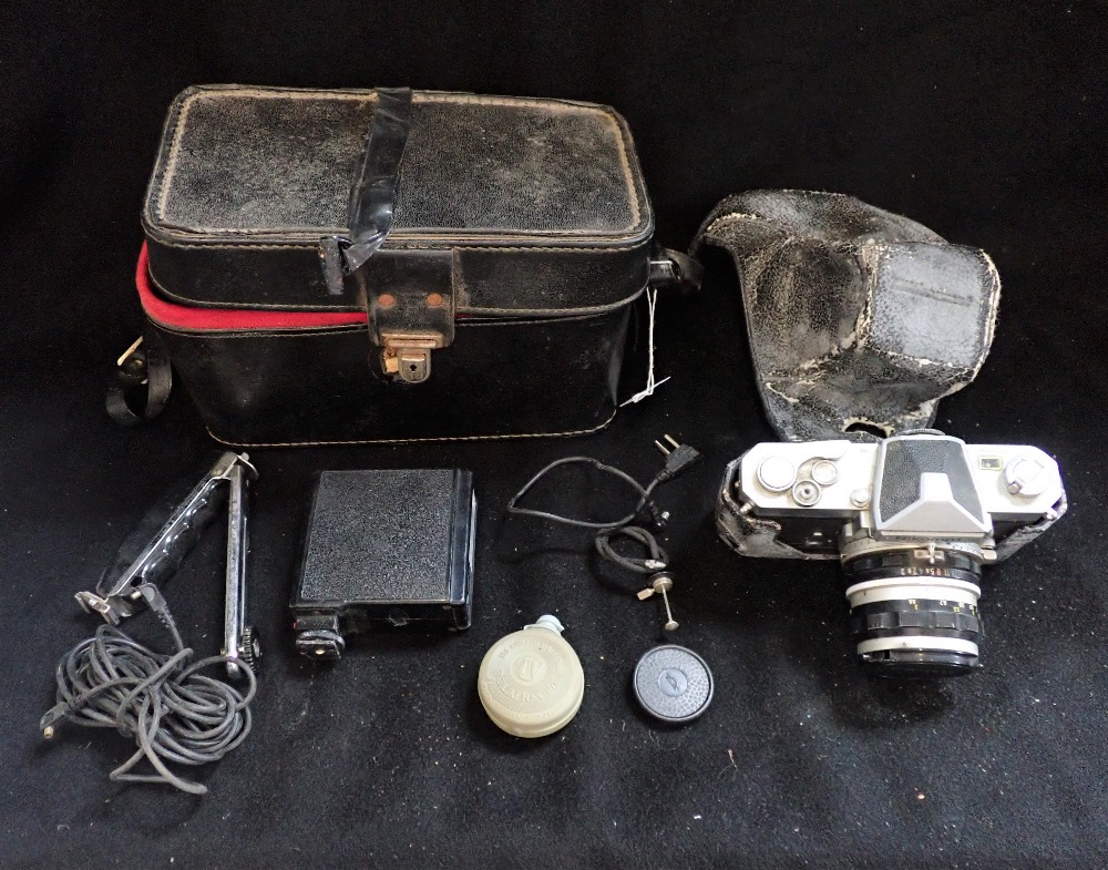 A NIKOMAT CAMERA with outer case and accessories
