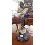 AN ART NOUVEAU STYLE BRONZE FIGURE OF A GIRL standing on, and holding, large flowers, 57cms high