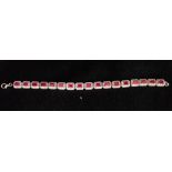 A RED AND WHITE GEM-STONE LINE BRACELET, the ring clasp stamped '925'