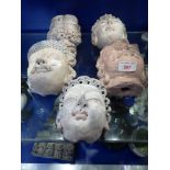 A COLLECTION OF CAST ASIAN HEADS (5)