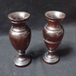 A PAIR OF EARLY 20TH CENTURY TURNED LIGNUM VITAE VASES