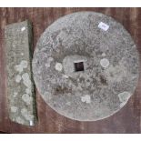 A GRIND STONE WITH SQUARE AXLE HOLE