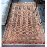 A CREAM GROUND RUG WITH RED AND BLACK DESIGN