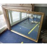 A GILT FRAME WALL MIRROR WITH BEVELLED PLATE