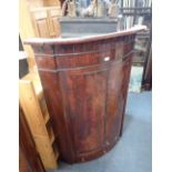 A 19TH CENTURY MAHOGANY BOW FRONTED HANGING CORNER CUPBOARD