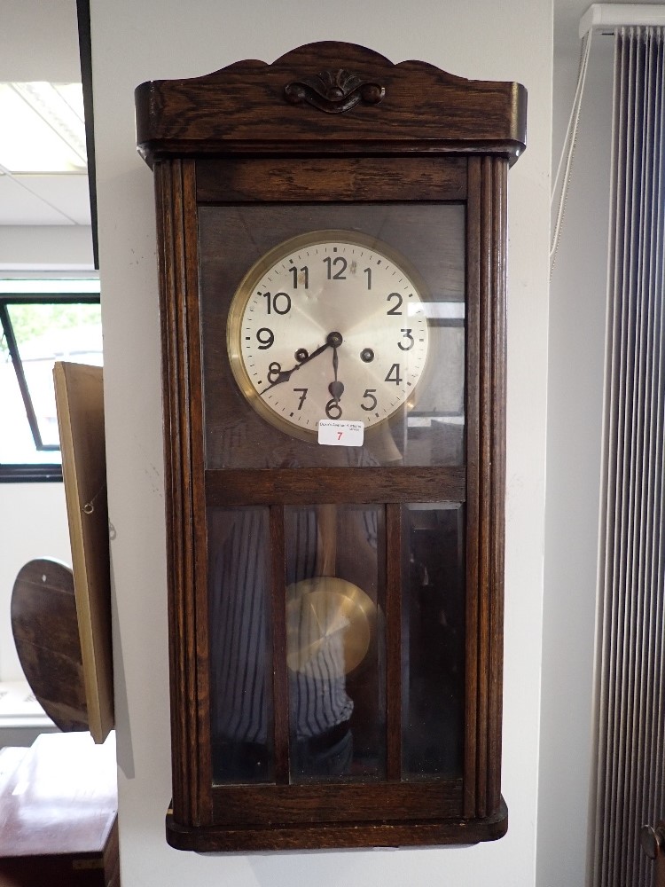 A 20TH CENTURY OAK WALL CLOCK