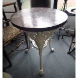 A PAINTED CAST IRON AND LATER WOOD MOUNTED GARDEN TABLE