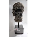 A CARVED STONE HEAD OF A GOD