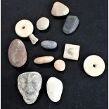 A COLLECTION OF CARVED STONE ARTEFACTS