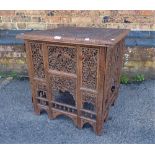 AN INDIAN CARVED HARDWOOD FOLDING TABLE