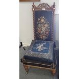 A VICTORIAN CARVED ROSEWOOD AND TAPESTRY WORK UPHOLSTERED LOW CHAIR