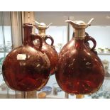 FOUR BROWN GLASS JUGS