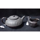 A 19TH CENTURY WEDGWOOD BLACK BASALT TEAPOT