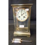 A BRASS TABLE CLOCK