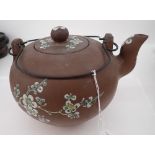 A TERRACOTTA OVOID TEAPOT AND LID